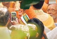 A family member takes photo of the wedding ceremony