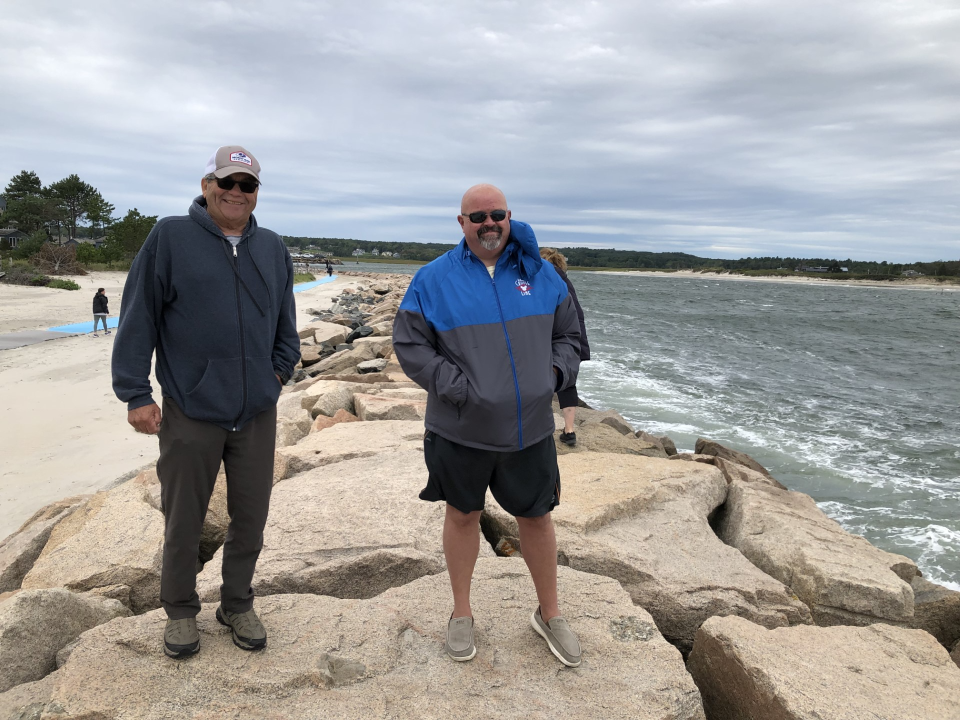 Mike Murray, left, of Lowell, Massachusetts, and Scott Lauren, of Goffstown, New Hampshire, are seen here on the jetty at Wells Beach, as Hurricane Lee approaches and the Atlantic Ocean roils close by on Saturday, Sept. 16, 2023.