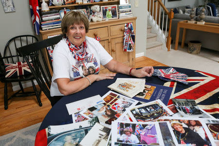 FILE PHOTO: Royal superfan Donna Werner poses with some of the photos and memorabilia she has collected traveling to England for the weddings of Prince Andrew, Prince William and Queen Elizabeth's 90th birthday celebration, at her home in New Fairfield, Connecticut, U.S. March 20, 2018. REUTERS/Michelle McLoughlin