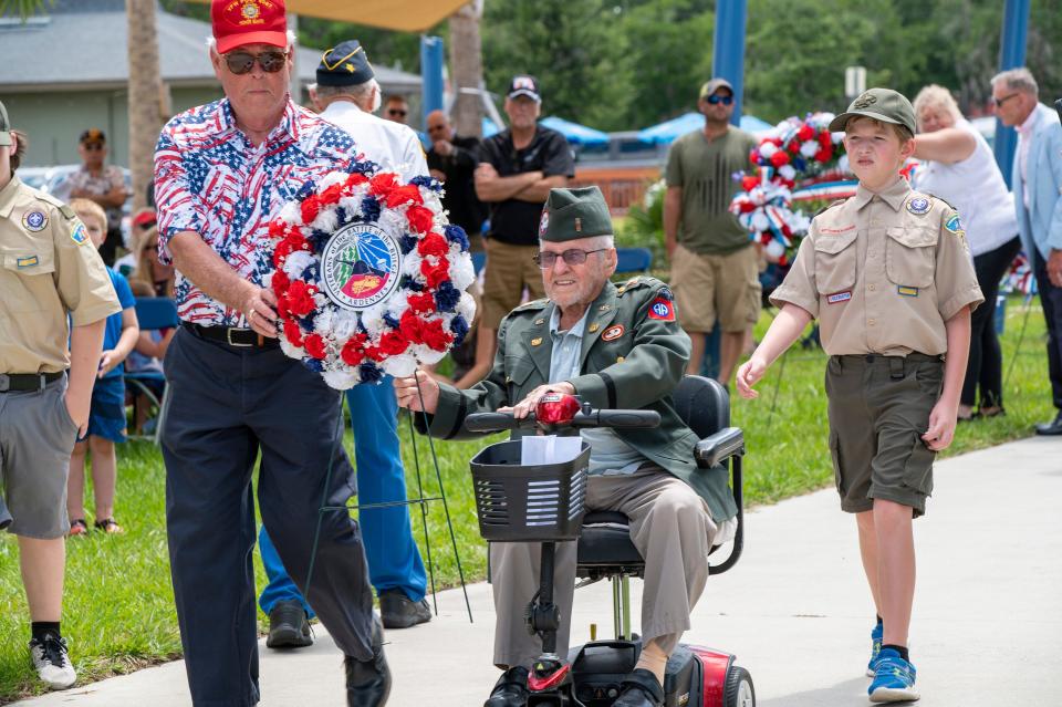 Guest of honor, John Bellefontaine, brings a wreath in honor of those killed during the Battle of the Bulge at the 12th annual Memorial Day Service in Eustis on Monday. [Cindy Peterson/Correspondent]