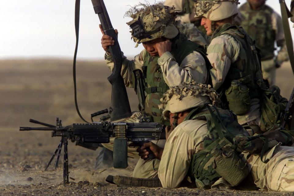 Marines stationed at Camp Rhino in Afghanistan perform a weapons test.