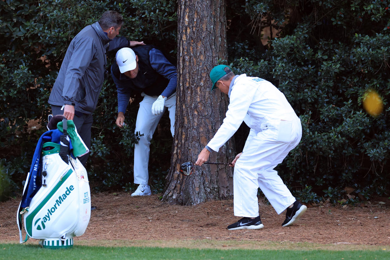 AUGUSTA, GEORGIA - APRIL 09: Scottie Scheffler prepares to take a drop on the 18th hole during the third round of the Masters at Augusta National Golf Club on April 09, 2022 in Augusta, Georgia. (Photo by David Cannon/Getty Images)