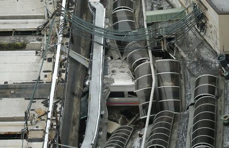 A derailed New Jersey Transit train is seen under a collapsed roof after it derailed and crashed into the station in Hoboken, New Jersey, U.S. on September 29, 2016. REUTERS/Carlo Allegri/File Photo