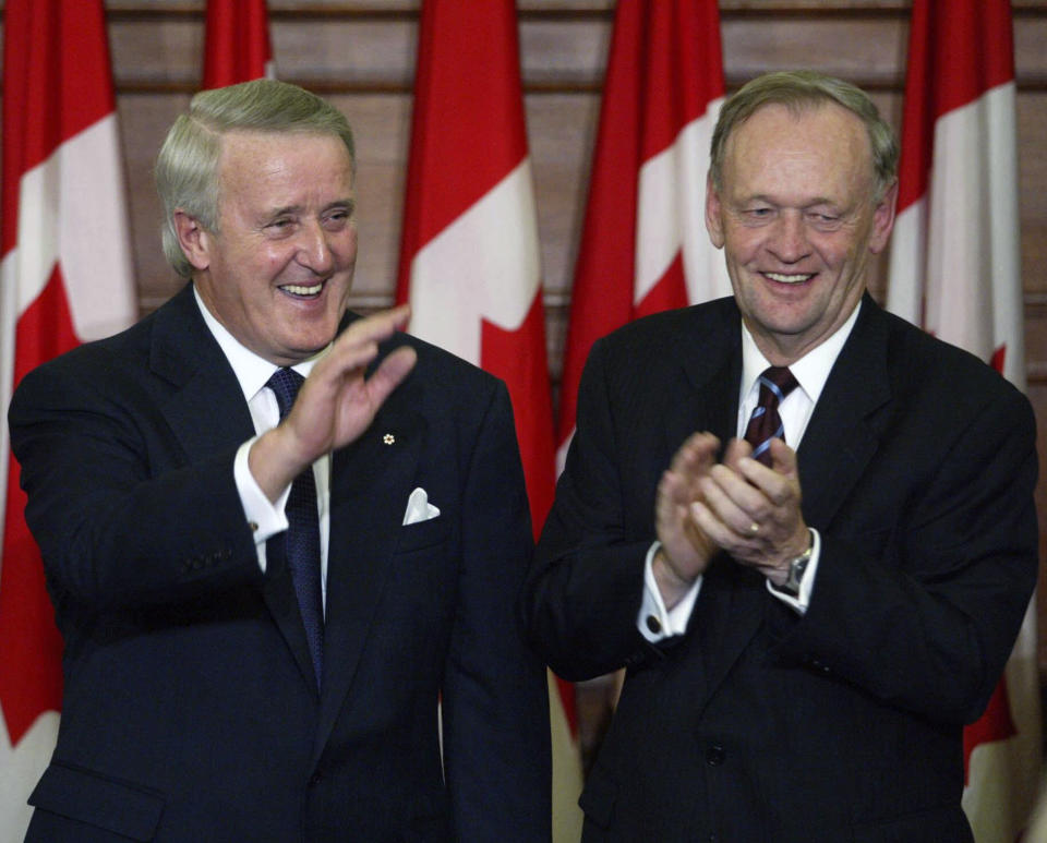 Canadian Prime Minister Jean Chretien, right, applauds former Prime Minister Brian Mulroney during an official unveiling ceremony of Mulroney's official portrait on Parliament Hill in Ottawa, Ontario, Tuesday, Nov 19, 2002. Mulroney has died at the age of 84, his daughter Caroline Mulroney posted on social media, Thursday, Feb. 29, 2024. (Tom Hanson/The Canadian Press via AP)