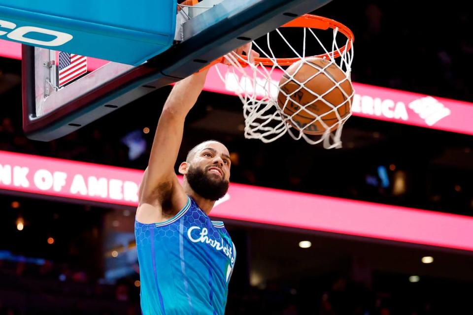 Charlotte Hornets forward Cody Martin (11) slam dunks the ball over Dallas Mavericks defense during a game at Spectrum Center in Charlotte, N.C., Saturday, March 19, 2022. Charlotte beat Dallas 129-108.