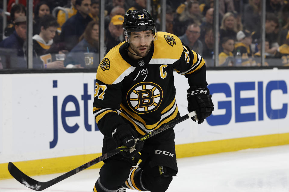 FILE - Boston Bruins' Patrice Bergeron is shown during the first period of an NHL hockey game against the Pittsburgh Penguins, Saturday, April 16, 2022, in Boston. Bruins captain Patrice Bergeron is coming back for another season. Almost three months after he left the ice without any certainty that he would return, the five-time Selke Trophy winner signed a one-year deal with the Bruins on Monday, Aug. 8, 2022. (AP Photo/Winslow Townson, File)