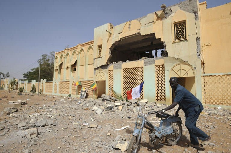 A Malian man passes by a building of the rebels of the Movement for Oneness and Jihad in West Africa (MUJAO) which has been destroyed by French air strikes on February 2, 2013 in Gao