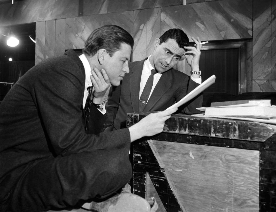FILE - In this Feb. 10, 1955, file photo, television writer Rod Serling, right, huddles with producer-director Fielder Cook, backstage at a New York rehearsal for a precedent-making telecast of Serling's "Patterns," on Television Theater. Years before he journeyed to "The Twilight Zone," Serling made a brief detour to the strike zone, writing a comedy about baseball. (AP Photo/Bob Wands, File)
