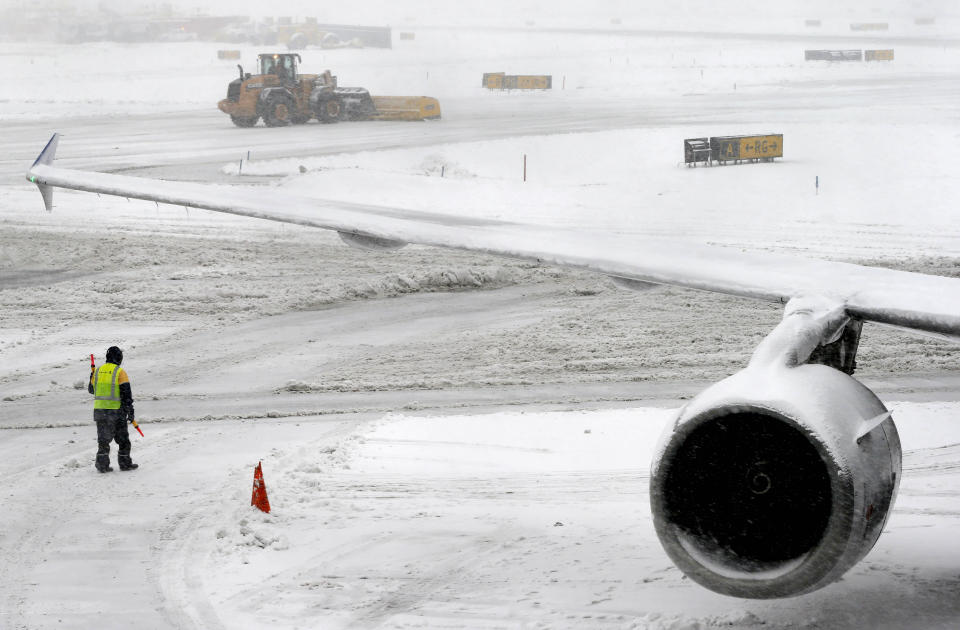 A snow plow clears the runway Monday, Feb. 3, 2014 at Newark Liberty International Airport in Newark, NJ. Air traffic is disrupted in Ohio, the Mid-Atlantic and the Northeast as another winter storm bears down on the eastern U.S., only a day after temperatures soared into the 50s. (AP Photo/Matt York)