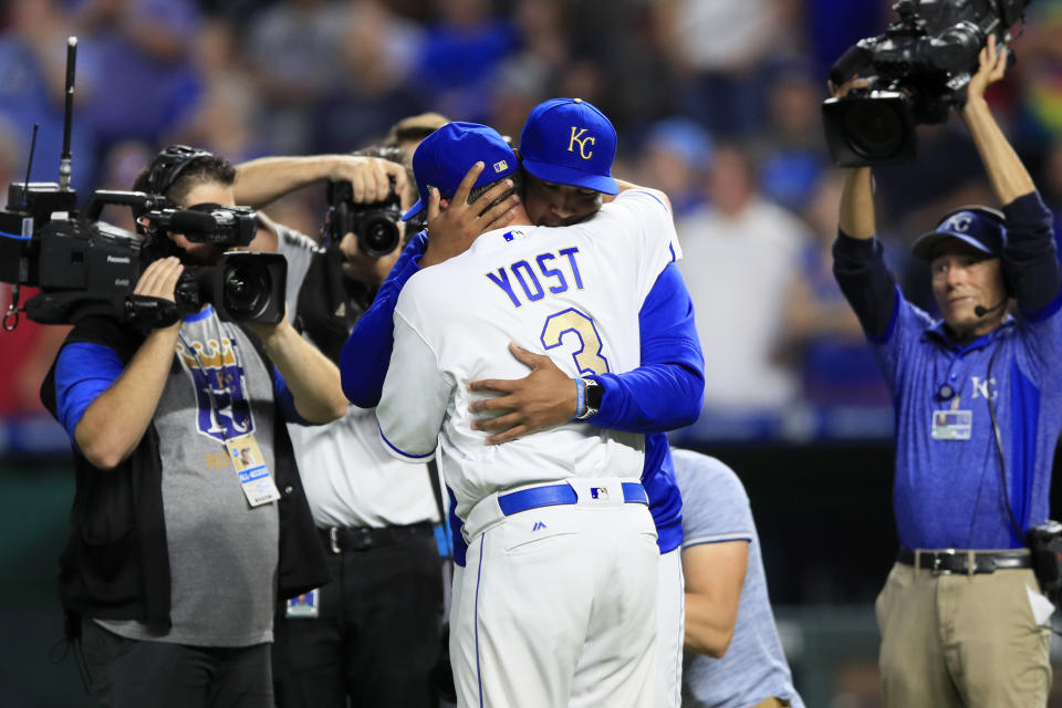 Kansas City Royals' Salvador Perez hugs manager Ned Yost (3) during a ceremony before a baseball game against the Minnesota Twins at Kauffman Stadium in Kansas City, Mo., Friday, Sept. 27, 2019. (AP Photo/Orlin Wagner)