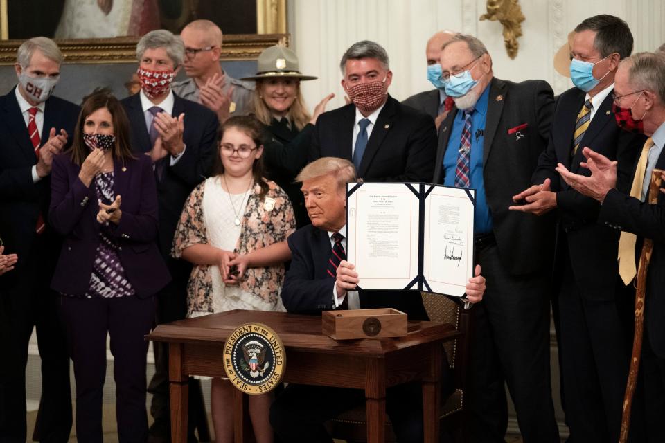 President Donald Trump signs the Great American Outdoors Act during a singing ceremony in the East Room of the White House on Aug. 4 in Washington, D.C. (Drew Angerer via Getty Images)