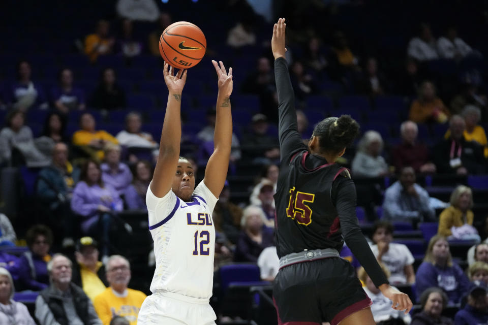 LSU guard Mikaylah Williams (12) shoots against Loyola New Orleans guard Deniya Thornton (15) in the first half an NCAA college basketball exhibition game in Baton Rouge, La., Wednesday, Nov. 1, 2023. (AP Photo/Gerald Herbert)