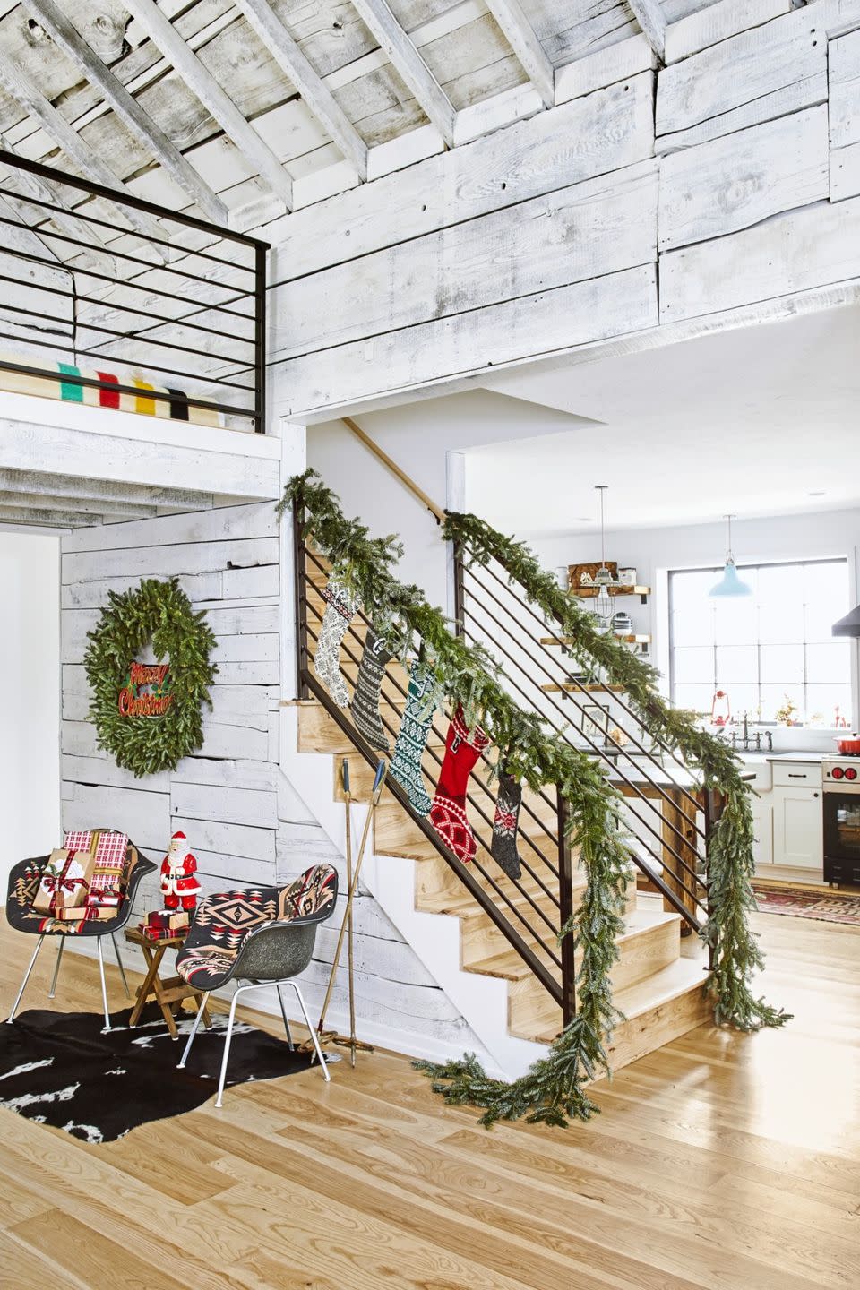 <p>The end of the staircase, decorated with fresh greenery and a row of stockings, becomes a Christmas "moment" complete with a seating area, packages, and a script Merry Christmas sentiment framed by a round wreath.</p><p><a class="link " href="https://go.redirectingat.com?id=74968X1596630&url=https%3A%2F%2Fwww.shopterrain.com%2Fsearch%3Futf8%3D%25E2%259C%2593%26q%3Dfresh%2Bwreath%26button%3Dsearch%26authenticity_token%3Df7AMatIZ3myGEu0KF1a2Txc3FG8JI%252FqbD1S7JFmfYg1ff41Z62g9jV%252F4adbOdzET%252BKThs0g%252FyKLZutiUCX8X%252Bg%253D%253D&sref=https%3A%2F%2Fwww.countryliving.com%2Fhome-design%2Fdecorating-ideas%2Fg23362967%2Fchristmas-decorations-for-stairs%2F" rel="nofollow noopener" target="_blank" data-ylk="slk:SHOP FRESH WREATHS;elm:context_link;itc:0;sec:content-canvas">SHOP FRESH WREATHS</a></p>