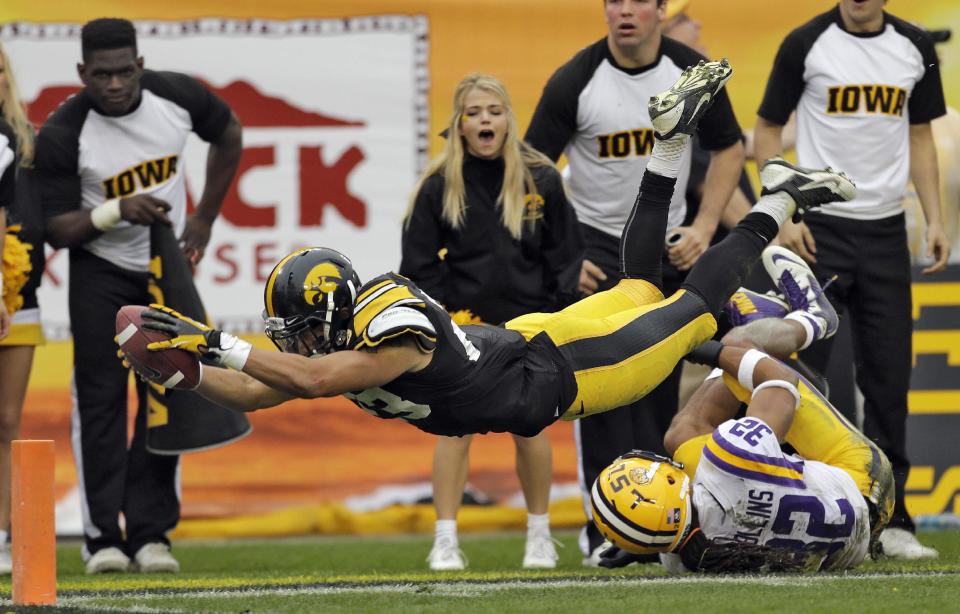 Iowa wide receiver Jordan Cotton (23) dives for the end zone after getting tripped up by LSU cornerback Jalen Collins (32) on a kickoff return during the fourth quarter of the Outback Bowl NCAA college football game Wednesday, Jan. 1, 2014, in Tampa, Fla. Officials ruled Cotton went out-of-bounds on the 4-yard line. LSU won the game 21-14. (AP Photo/Chris O'Meara)