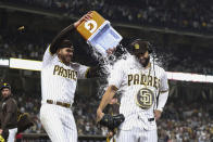 San Diego Padres' Joe Musgrove, left, dumps water onto Eric Hosmer during an interview after the Padres defeated the Cincinnati Reds in a baseball game Thursday, June 17, 2021, in San Diego. (AP Photo/Derrick Tuskan)