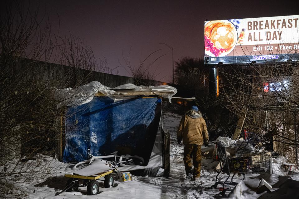 An outreach worker delivers supplies to people living in a homeless camp on December 23, 2022 in Louisville, Kentucky (Getty Images)