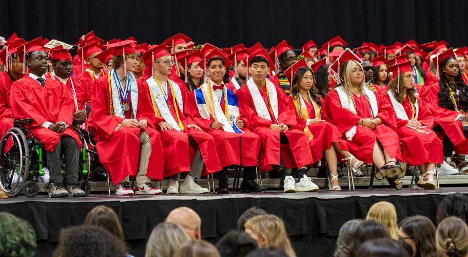 Class officers and others fill the front row of graduates during the South High Community School graduation at the DCU Center Friday.