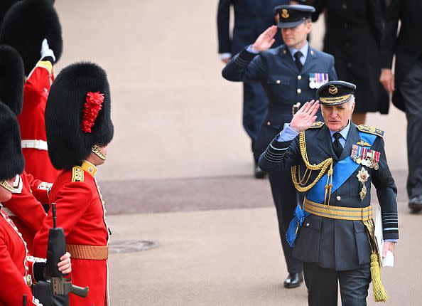 WINDSOR, ENGLAND - SEPTEMBER 19: A member of the Royal Air Force salutes as they arrive at The Committal Service for Queen Elizabeth II at Windsor Castle on September 19, 2022 in Windsor, England. The committal service at St George's Chapel, Windsor Castle, took place following the state funeral at Westminster Abbey. A private burial in The King George VI Memorial Chapel followed. Queen Elizabeth II died at Balmoral Castle in Scotland on September 8, 2022, and is succeeded by her eldest son, King Charles III. (Photo by Leon Neal/Getty Images)