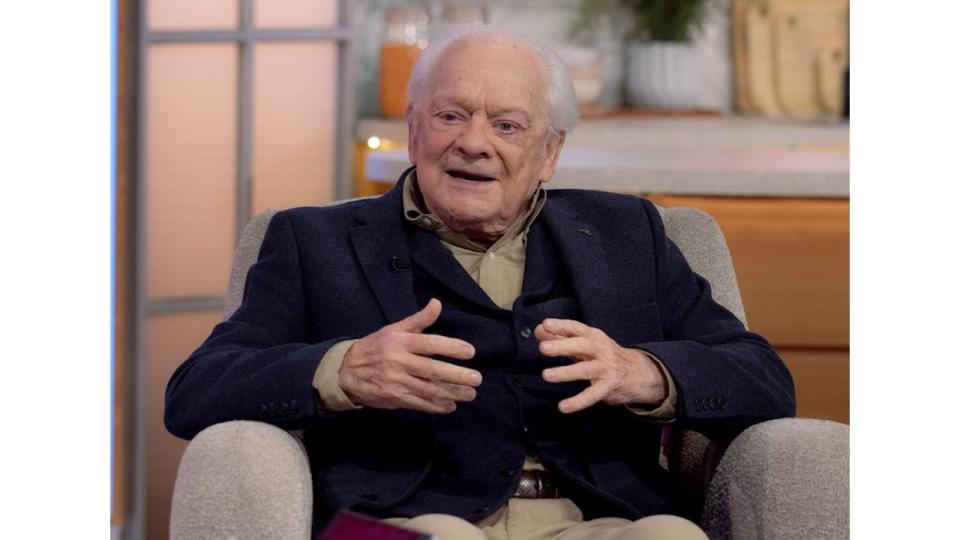 Sir David Jason sitting in a chair