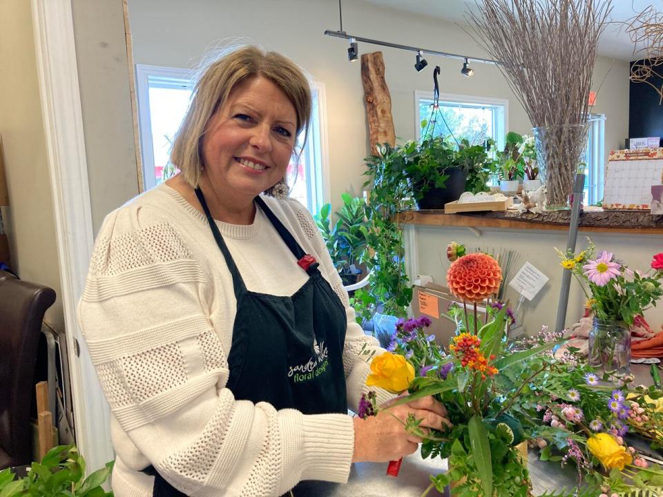 Florist Sandra Miller has sold plenty of funerary flower arrangements, including one that incorporated a pair of moose horns. (Mariam Mesbah/CBC)