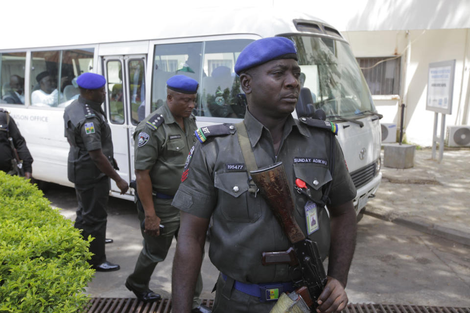 Security men stand guard in front of a bus conveying All progressives Congress opposition governors after visiting victims of at the Accident and Emergency unit of Asokoro hospital where injured people from Monday's explosion at a bus station are receiving treatment in Abuja, Nigeria, Wednesday, April 16, 2014. Scores of peopledied in the the blast that destroyed more than 30 vehicles and caused secondary explosions as their fuel tanks exploded and burned. The Monday attack just miles from Nigeria's seat of government increases doubts about the military's ability to contain an Islamic uprising that is dividing the country on religious lines as never before. (AP Photo/ Sunday Alamba)