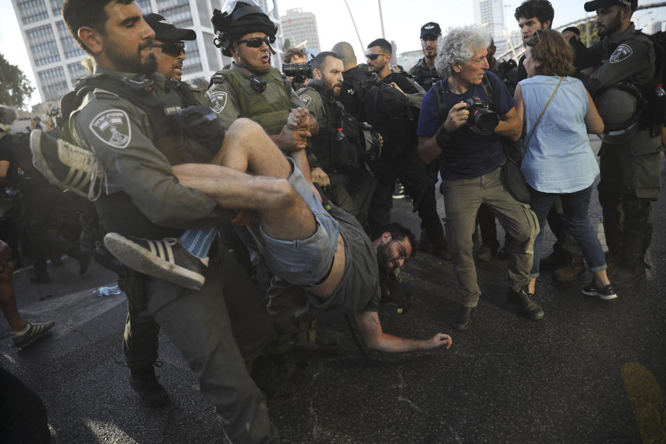 Police arrest a a man during a protest in Tel Aviv, Israel, Wednesday, July 3, 2019. Israeli police were bracing for another day of violent protests Wednesday after community activists called for renewed street demonstrations in response to the killing of an Ethiopian-Israeli teen by an off-duty police officer. (AP Photo/Oded Balilty)