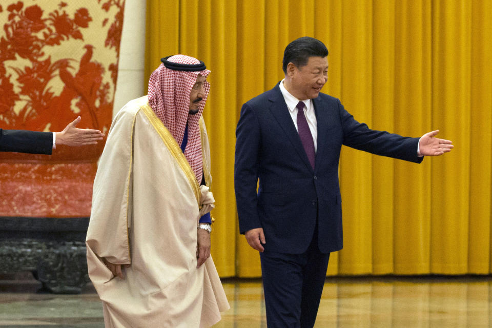 Chinese President Xi Jinping shows the way for Saudi Arabia's King Salman during a welcome ceremony at the Great Hall of the People in Beijing, China, Thursday, March 16, 2017. (AP Photo/Ng Han Guan)