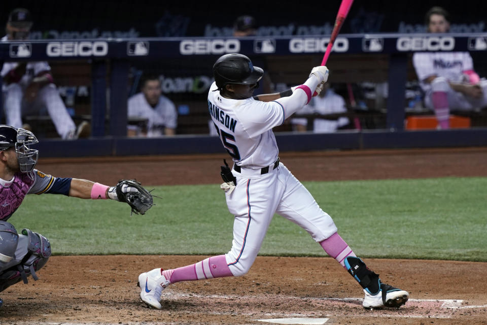 Miami Marlins right fielder Lewis Brinson (25) hits a solo home run in the seventh inning of a baseball game against the Milwaukee Brewers, Sunday, May 9, 2021, in Miami. (AP Photo/Marta Lavandier)