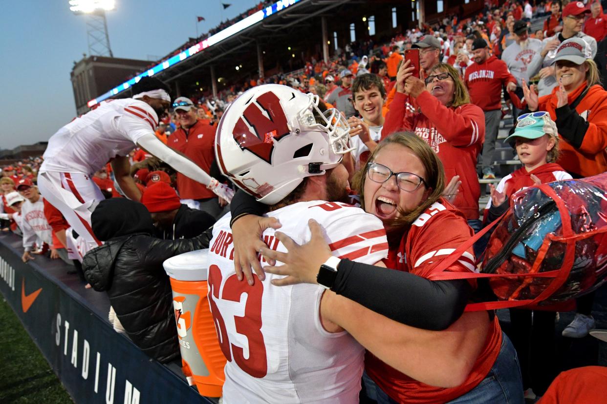 Wisconsin offensive lineman Tanor Bortolini gets a hug from a fan after a game against Illinois at Memorial Stadium on Oct 21, 2023.