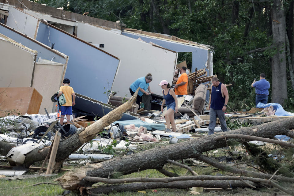 People survey the damage to their home that was destroyed by a tornado on Wednesday, July 19, 2023, in Dortches, N.C. (AP Photo/Chris Seward)