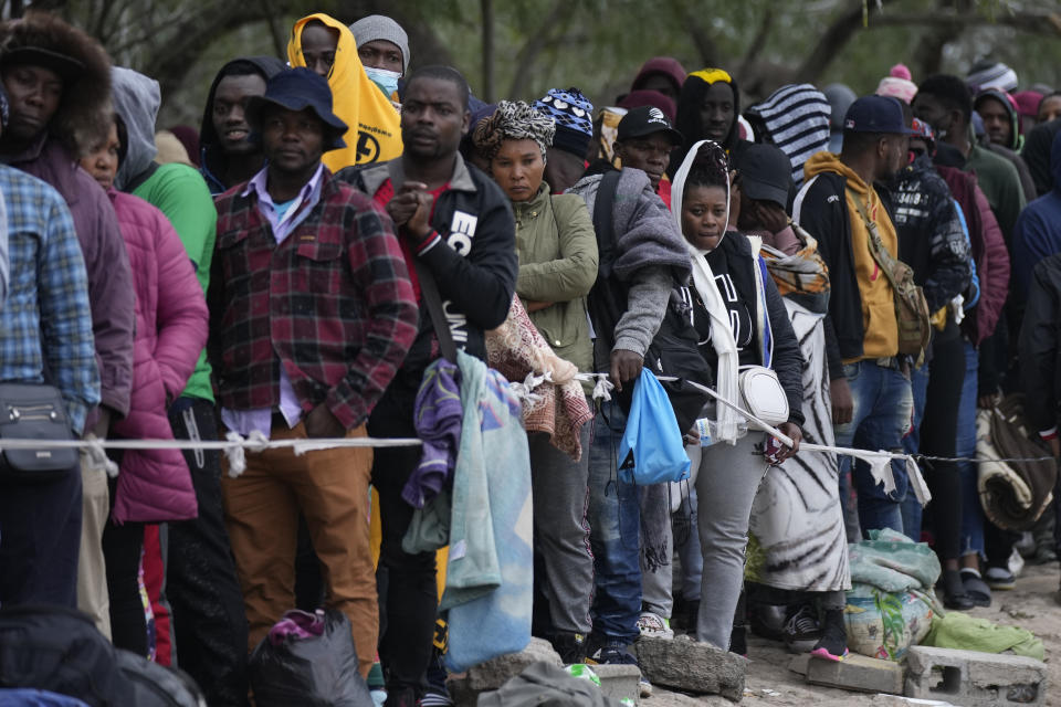 FILE - Haitian migrants who hope to apply for asylum in the U.S. wait to register their names on a list made by a religious organization in Reynosa, Mexico, Dec. 21, 2022, on the other side of the border with McAllen, Texas. (AP Photo/Fernando Llano, File)