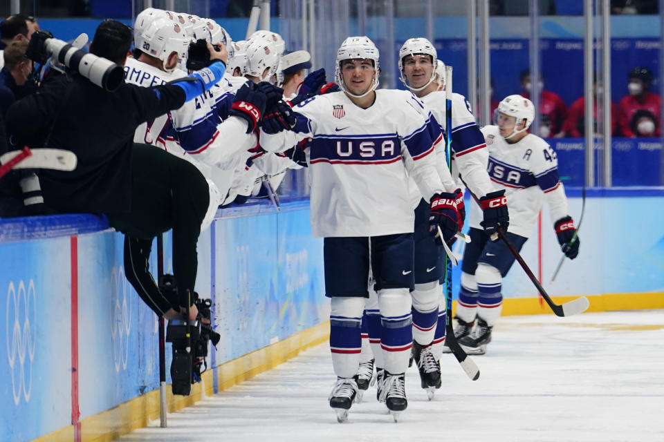 United States' Brendan Brisson (19) is congratulated after scoring a goal against Canada during a preliminary round men's hockey game at the 2022 Winter Olympics, Saturday, Feb. 12, 2022, in Beijing. (AP Photo/Matt Slocum)
