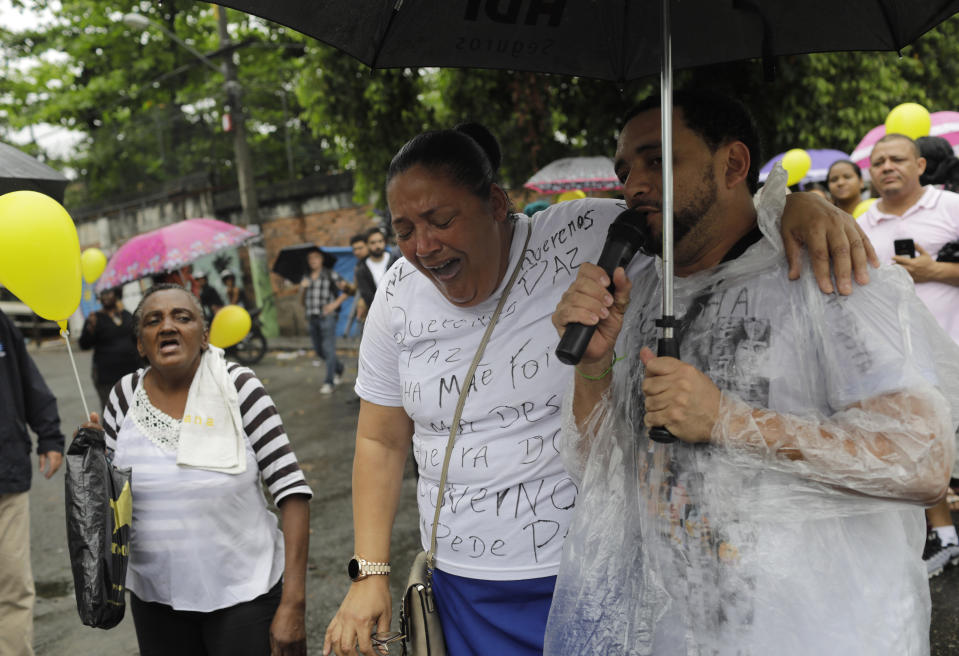 A woman cries during a protest and gathering in memory of the late 8-year-old Ágatha Sales Félix, whose photo of her clutching a yellow balloon is circulating online, as residents demand an end to the violence in the Alemao complex slum of Rio de Janeiro, Brazil, Sunday, Sept. 22, 2019. Félix was hit by a stray bullet Friday amid what police said was shootout with suspected criminals. However, residents say there was no shootout, and blame police. (AP Photo/Silvia Izquierdo)