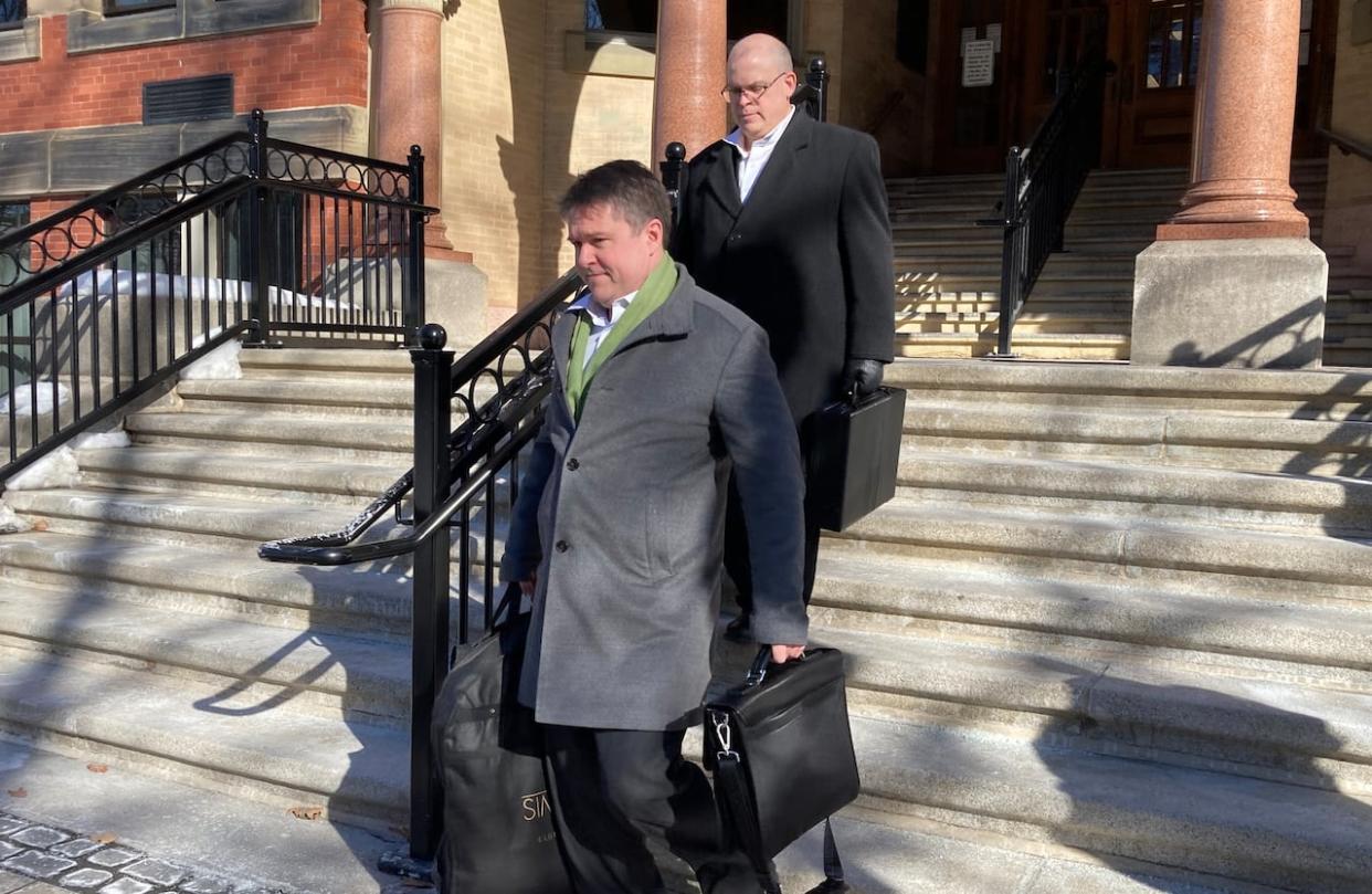 Government lawyers Michael Hynes, left, and John Gillis leave the New Brunswick Court of Appeal Friday. (Jacques Poitras/CBC - image credit)