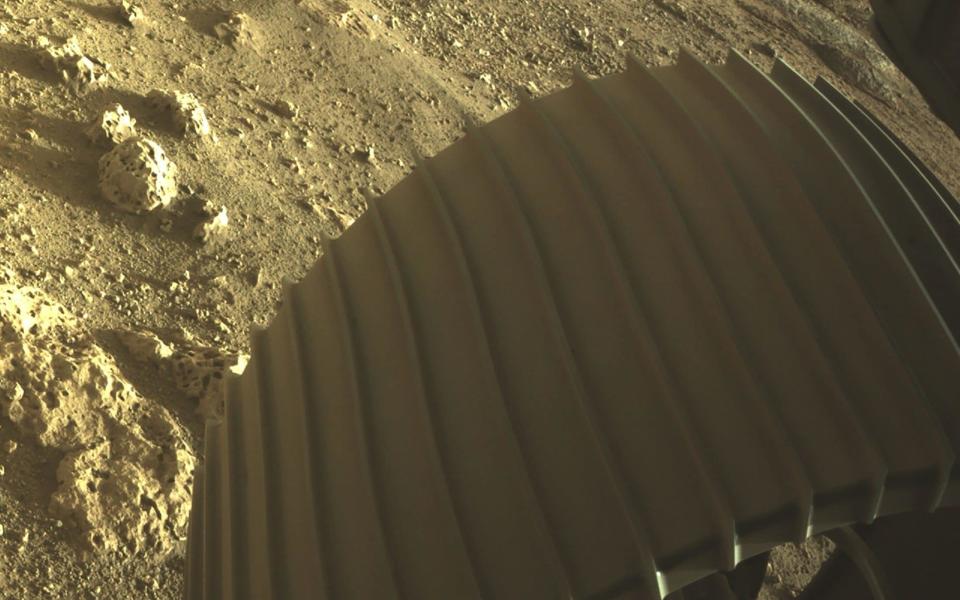 Yellow-ish rocks beneath the rover's front wheel - REUTERS