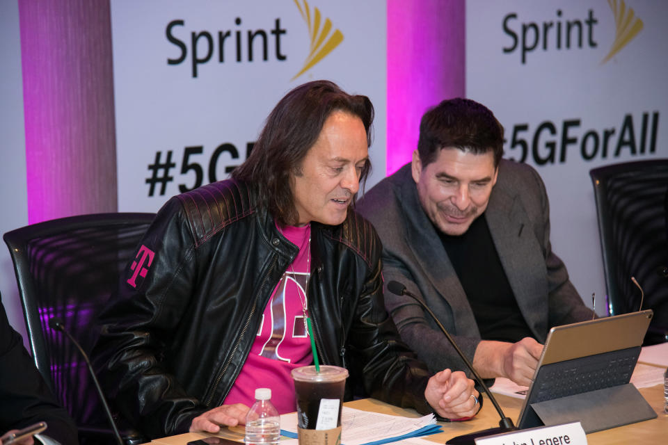 John Legere and Marcelo Claure sitting next to each other