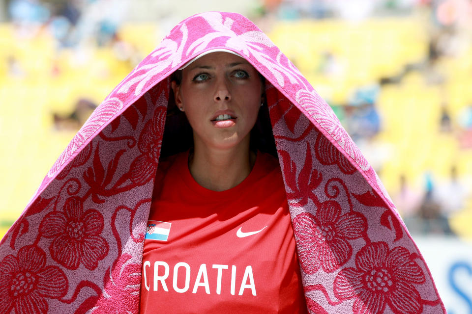 DAEGU, SOUTH KOREA - SEPTEMBER 01: Blanka Vlasic of Croatia uses a towel to shelter from the sun during the women's high jump qualification round during day six of the 13th IAAF World Athletics Championships at the Daegu Stadium on September 1, 2011 in Daegu, South Korea. (Photo by Alexander Hassenstein/Bongarts/Getty Images)