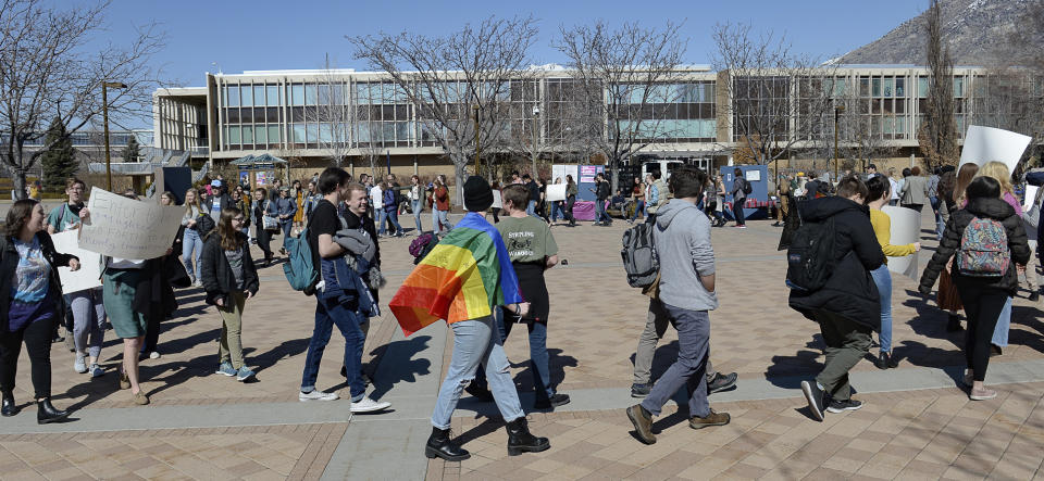 FILE - Students protest outside the student center at Brigham Young University in Provo, Utah, on Wednesday, March 4, 2020, after an official with the Church of Jesus Christ of Latter-day Saints school issued a clarification to the school's Honor Code, which said that same-sex romantic behavior is still "not compatible" with the rules at BYU. The U.S. Department of Education has opened a civil-rights investigation into how LGBTQ students are disciplined at Brigham Young University, a private religious school. The complaint under investigation came after the school said it would still enforce a ban on same-sex dating even after that section was removed from the written version of the school's honor code, the Salt Lake Tribune reported. (Francisco Kjolseth/The Salt Lake Tribune via AP, File)