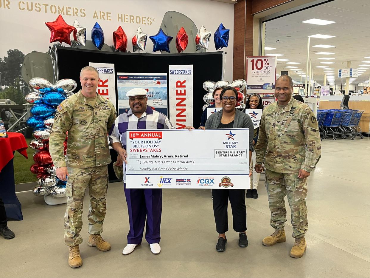 A Hephzibah resident and Desert Storm veteran won a worldwide sweepstakes and had his entire credit card bill paid off at a presentation Tuesday at the Fort Eisenhower Army & Air Force Exchange Service. (From left to right: Fort Eisenhower Garrison Command Sgt. Maj. Aaron Rose, sweepstakes winner retired Staff Sgt. James Mabry, Fort Eisenhower Exchange General Manager LaToya Harris, Fort Eisenhower Garrison Commander Col. Reggie Evans.)