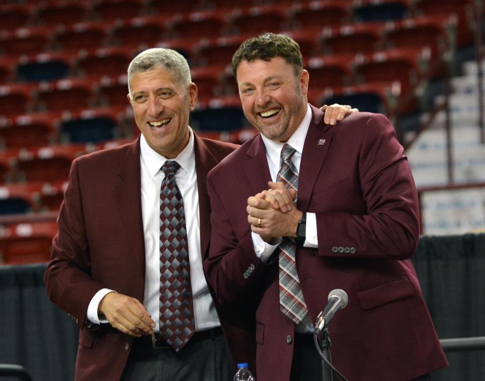 New NMSU Aggie Basketball Coach Greg Heiar laughs with athletic director Mario Moccia at his introductory press conference on March 28, 2022.