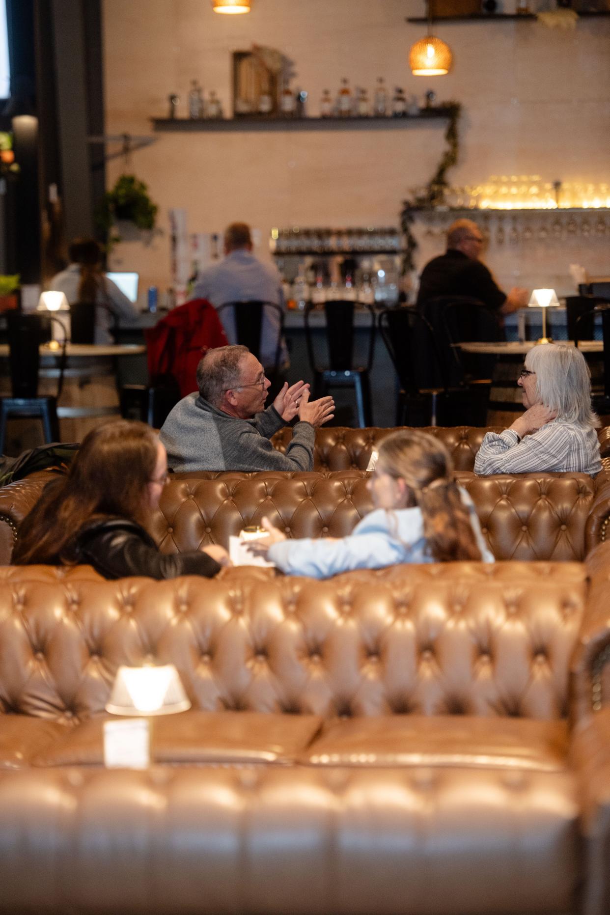 Patrons chat on couches at Cultivated Cocktails Distillery and Tavern in East Asheville, March 6, 2024.