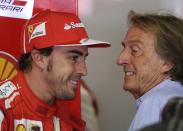 Ferrari Formula One driver Fernando Alonso (L) of Spain smiles with Ferrari president Luca di Montezemolo during the third practice session of the Italian F1 Grand Prix at the Monza circuit September 7, 2013. REUTERS/Max Rossi (ITALY - Tags: SPORT MOTORSPORT F1)