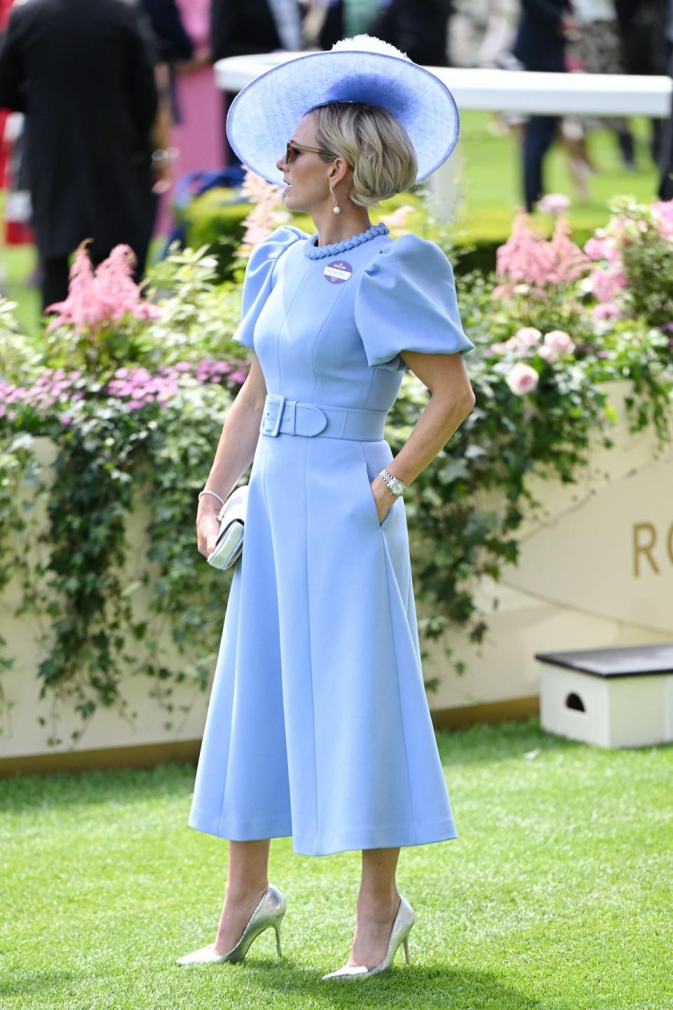 Zara Tindall wearing a powder blue dress with a coordinating hat.