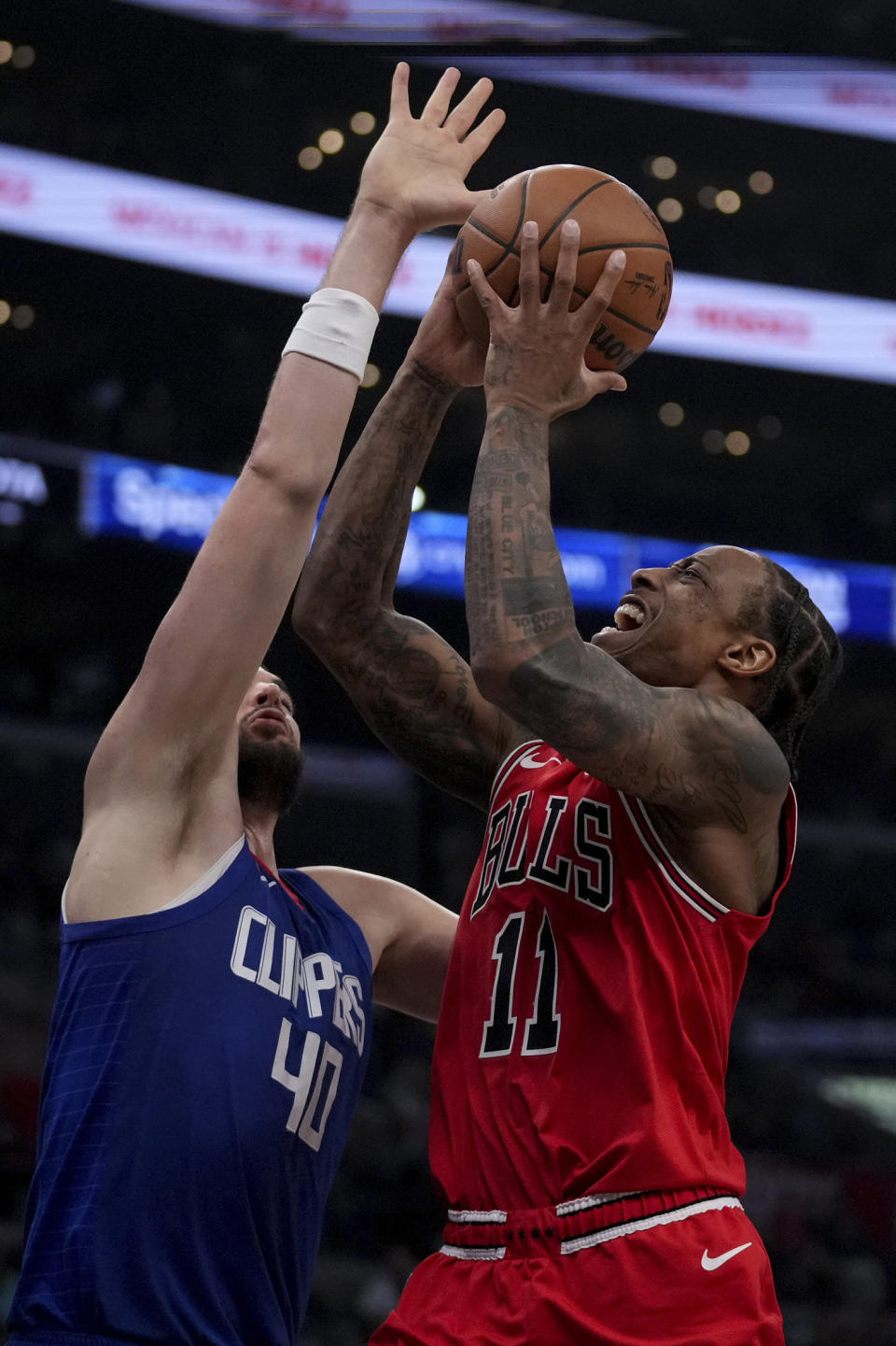 Chicago Bulls forward DeMar DeRozan (11) drives to the basket against Los Angeles Clippers center Ivica Zubac (40) during the second half of an NBA basketball game in Los Angeles, Saturday, March 9, 2024. (AP Photo/Eric Thayer)