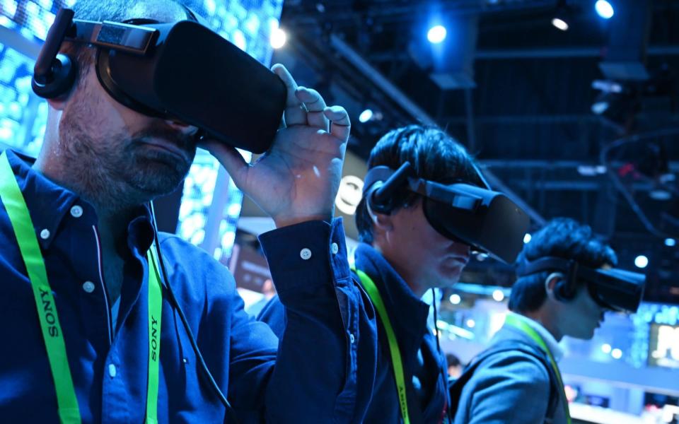 Attendees take a virtual reality tour at an Intel showcase in Las Vegas, January 2019 - AFP