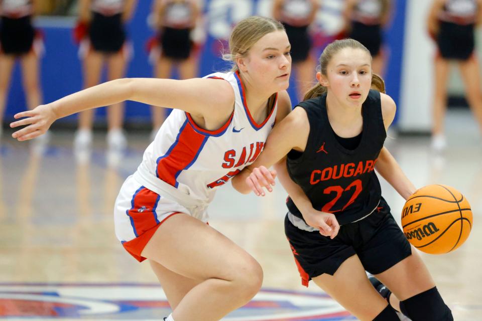 North Rock Creek's Kadence Munn, right, drives past Oklahoma Christian School's McKenna Chandler during a girls high school basketball game between North Rock Creek and Oklahoma Christian School in Edmond, Okla., Tuesday, Jan. 9, 2024.