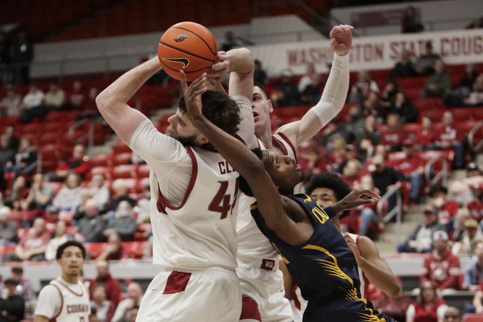 Washington State forwards Oscar Cluff, left, Andrej Jakimovski, center, and California guard Keonte Kennedy go after a rebound during the first half of an NCAA college basketball game Thursday, Feb. 15, 2024, in Pullman, Wash. (AP Photo/Young Kwak)