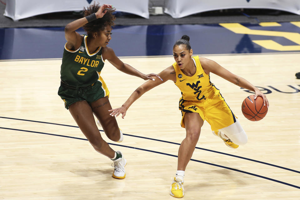 West Virginia guard Kysre Gondrezick, right, is defended by Baylor guard DiDi Richards during the first half of an NCAA college basketball game Thursday, Dec. 10, 2020, in Morgantown, W.Va. (AP Photo/Kathleen Batten)