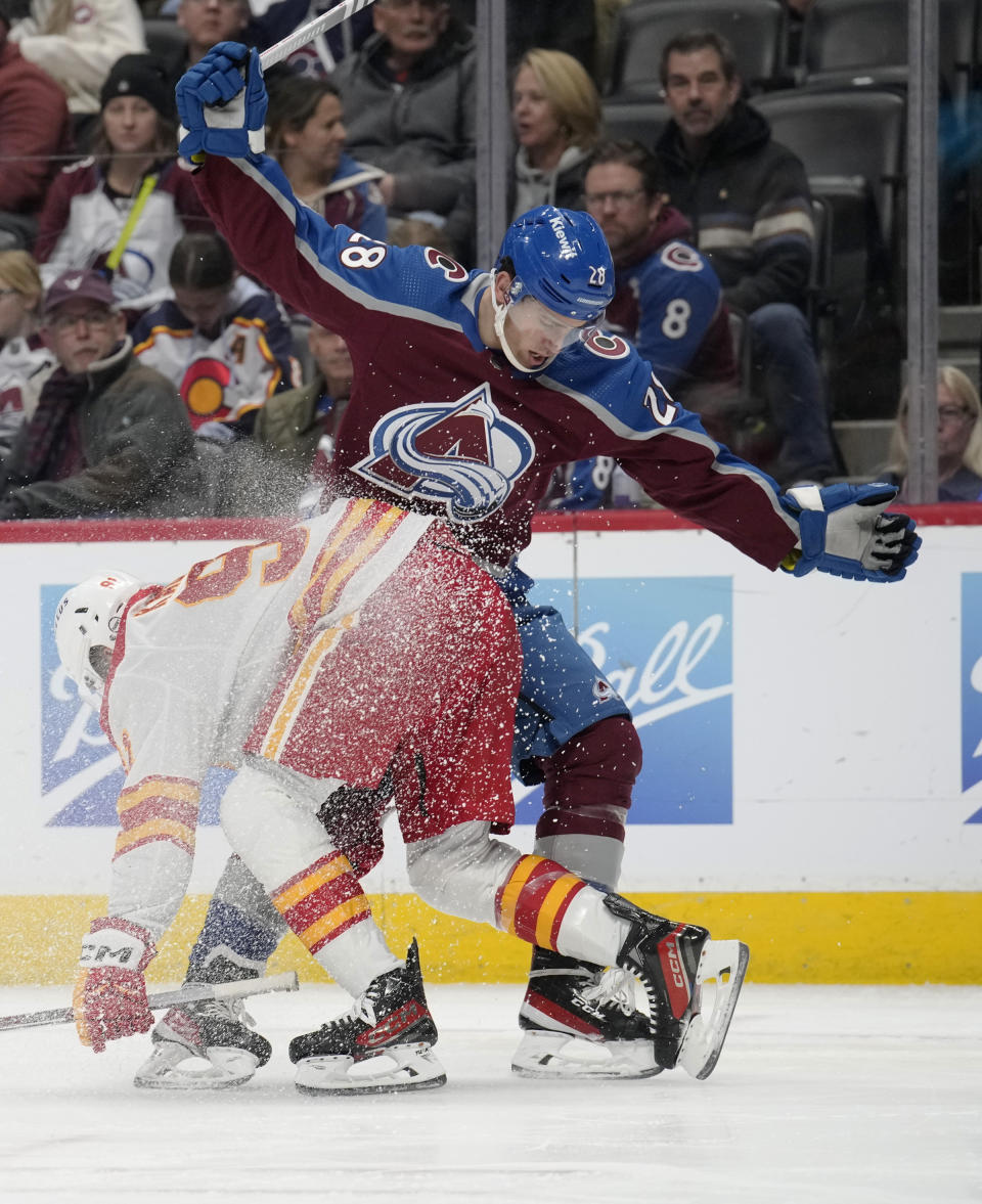 Calgary Flames center Nazem Kadri, left, becomes entangled with Colorado Avalanche left wing Miles Wood, right, in the second period of an NHL hockey game Monday, Dec. 11, 2023, in Denver. (AP Photo/David Zalubowski)