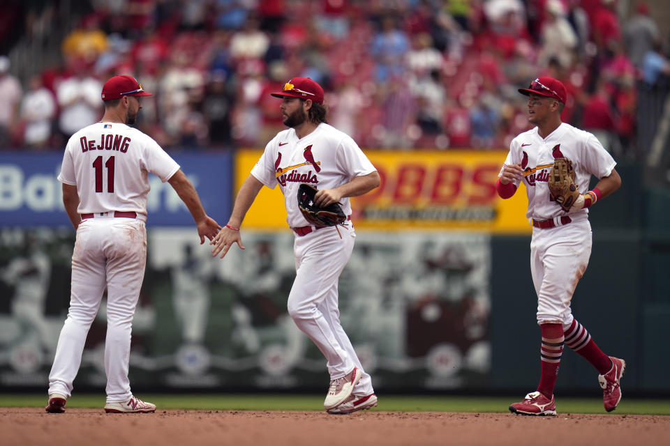 St. Louis Cardinals' Paul DeJong (11), Alec Burleson and Lars Nootbaar, right, celebrate a 6-4 victory over the Miami Marlins following a baseball game Wednesday, July 19, 2023, in St. Louis. (AP Photo/Jeff Roberson)